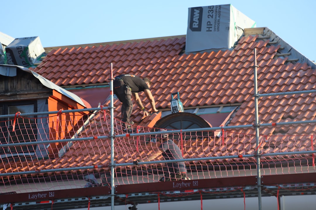 Professional roofing crew installing a new asphalt shingle roof on a residential home in Jackson, Tennessee